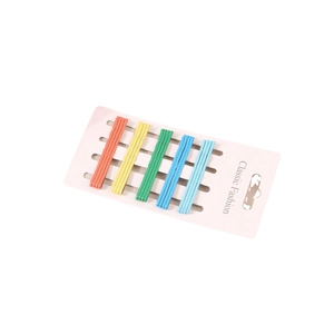 Set of 20 minimalist candy-colored metal bobby pins organized on a pink display card