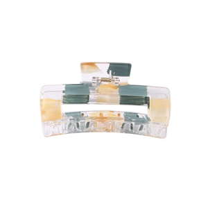 Detail of a geometric acrylic hair claw with transparent base and artistic gold foil pattern
