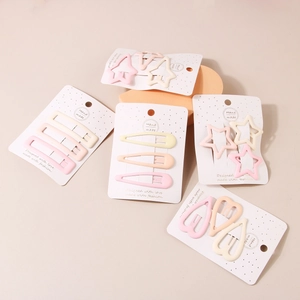 Pastel cream metal hair clips set in star and heart shapes on display cards