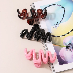Three-piece wave-shaped resin hair claws in tortoise shell, black, and soft pink colors