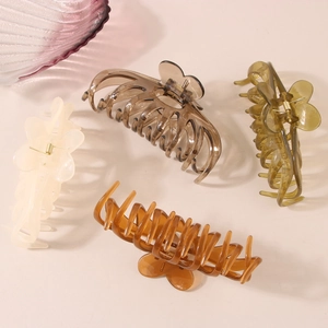 Set of four large transparent acrylic shark hair clips in neutral earth tones for women