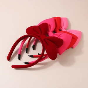 Set of four sweet handmade velvet bow headbands for girls in various shades of red and pink
