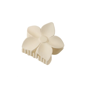 Detail view of matte cream flower hair claw clip with sturdy inner teeth for secure grip