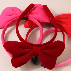 Detail of velvet bow headbands featuring handmade woven label and soft plush texture