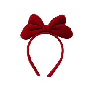Handmade red velvet bow headband for girls featuring soft matte texture and solid finish