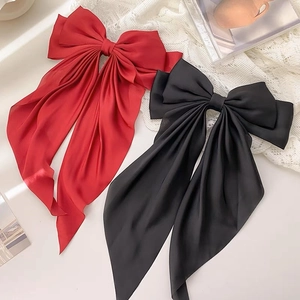 Elegant satin bow hair clips in red and black with long streaming ribbons for women