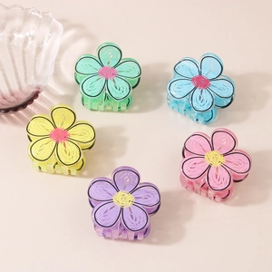 Close-up of colorful floral hair claws in five pastel shades with acrylic texture