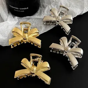 Elegant set of 4 metallic bow hair claws in gold and silver finish for half-up hair