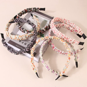 Detail of assorted floral fabric pleated headbands with elegant patterns and end tips
