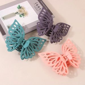 Matte double-layered butterfly hair claws in dark green, lilac, and coral pink