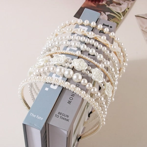 Detailed close-up of various elegant pearl headbands with golden metallic base designs