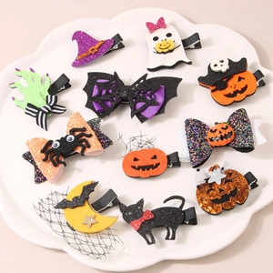 Detail of 10-piece Halloween hair clip set with glitter pumpkin and ghost designs
