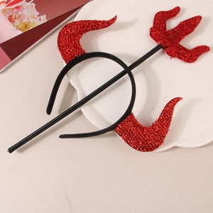 Macro view of red sequin devil horns headband and trident set on a decorative plate