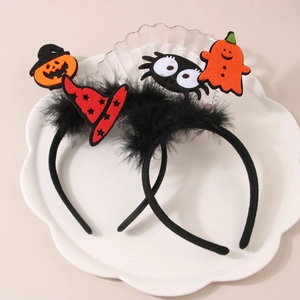 Detail of Halloween headbands with felt pumpkin, witch hat and ghost on black feathers