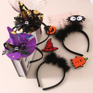 Detail of Halloween headbands with spider, pumpkin, and wizard hat designs on books