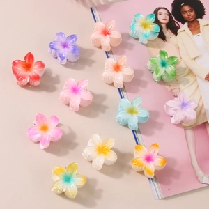 Set of 12 colorful 4cm frangipani flower hair claws in various vibrant gradient shades