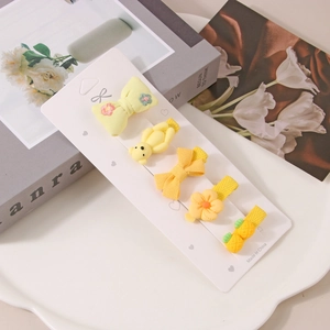 Detailset aus 5 gelben Haarspangen für Kinder mit Bären- und Blumenmustern aus Stoff