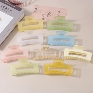 Detailed view of a 9-piece matte rectangle hair claw clip set in various soft pastel colors