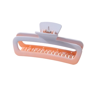 Large rectangular cutout hair claw clip with matte pink and orange gradient finish