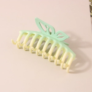 Detail of mint green and cream white gradient butterfly hair claw clip with matte finish