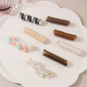 Spiral telephone wire hair ties in various colors and pearl accents with gold tips