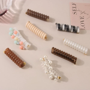 Spiral telephone wire hair ties in earthy tones with pearl and bead accents