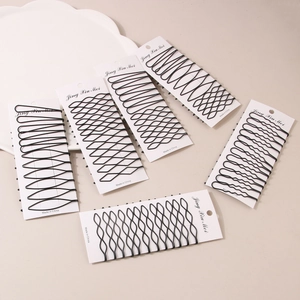 Close-up of matte black seamless hair clip sets with diverse patterns on white cards