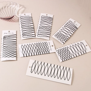 12-piece set of matte black seamless hair pins with straight and wavy designs on white cards