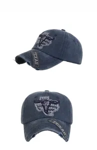 Detail of vintage washed blue baseball cap featuring Texas bull skull embroidery and frayed brim