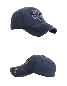 Close-up of vintage blue washed cotton baseball cap with Texas bull embroidery and distressed detail