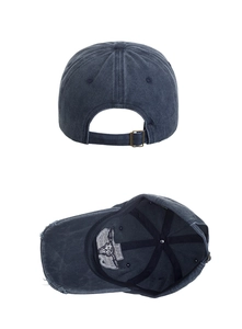 Detailed macro view of the vintage navy blue washed cotton cap with bull embroidery