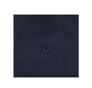 Detail shot of the navy blue twill fabric and embroidered eyelet on the baseball cap