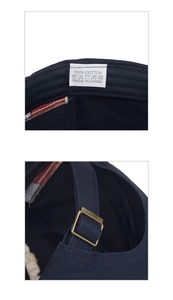 Detail view of 100% cotton navy baseball cap with vintage brass metal buckle adjustment