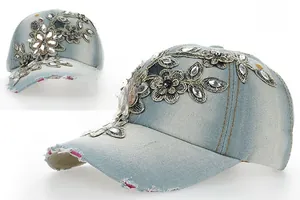 Detail of light blue denim baseball cap with floral embroidery and sparkling rhinestones