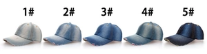 Detailed view of five denim baseball caps showing different faded washes from light to dark blue