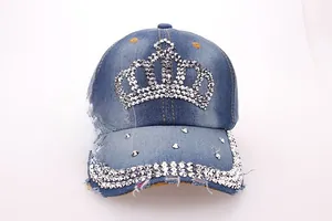 Detail of crown rhinestone embellishment on distressed blue denim baseball cap