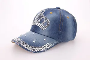 Detailed view of silver crown rhinestones and triple-row studs on washed denim cap