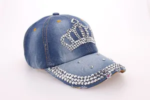 Close-up of crown rhinestone inlay and three rows of gems on washed denim baseball cap