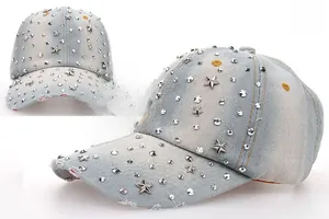 Close-up of light blue denim baseball cap with silver metal studs and star rivets