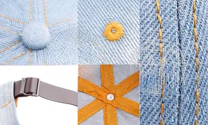 Detail view of denim baseball cap with yellow stitching and leather strap buckle