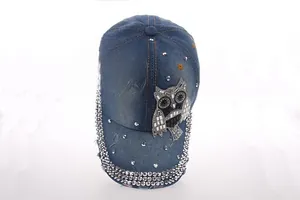 Detail of owl sequin embroidery and sparkling silver rhinestones on denim baseball cap