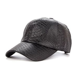 Close-up of black crocodile-pattern PU leather on a structured baseball cap