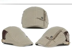 Detail view of khaki embroidered newsboy cap with vintage metal buckle and side stitching