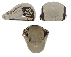 Detail view of khaki and brown patchwork beret with letter embroidery and metal buckle
