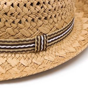 Classic British style straw sun hat with striped ribbon detail and woven texture