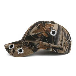 Outdoor camouflage baseball cap with bullet hole embroidery in brown tones shown at 45-degree angle