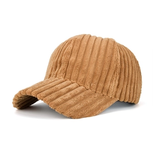 Detail of tan striped corduroy baseball cap texture and side profile on white background