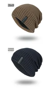 Detail view of khaki and navy blue beanie hats showing thick fleece lining and knit texture