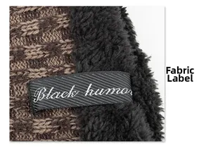 Detail showing knit texture with warm faux fleece lining and woven black humor label