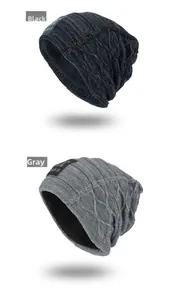 Detail of knit winter beanies in black and grey with warm fleece lining and letter patch